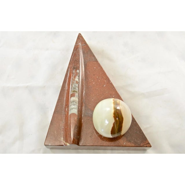 Large sienna - red Moroccan fossil stone triangular stand artisan carved to accentuate the extinct Devonian Period marine...