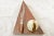 Large sienna - red Moroccan fossil stone triangular stand artisan carved to accentuate the extinct Devonian Period marine...