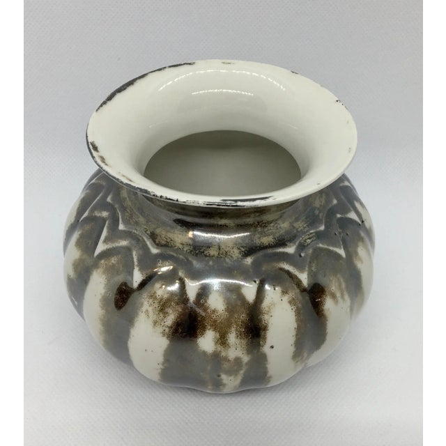 This small but beautiful vase will catch your attention with its unusual iridescent almost metallic burnished glaze color...