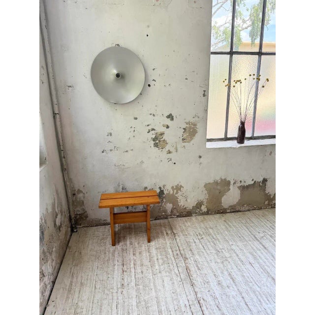 Antique pine stool in the style of mountain furniture, in the style of Charlotte Perriand's selections for arches. We love...