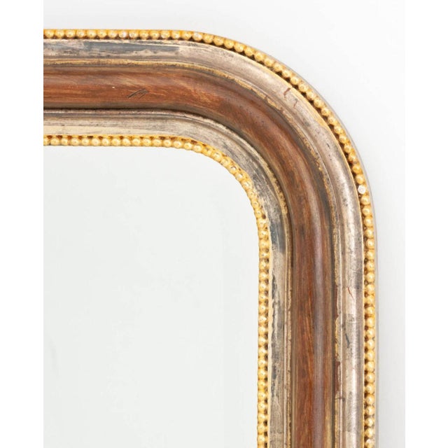 LaBarge Silvered and Giltwood Framed Beveled Glass Mirror, arch form with gilded beaded borders, label and marked "Made in...