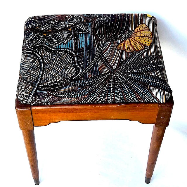 Offered is a lovely walnut wood vanity bench with a wool upholstered seat and brass capped legs. The lower sides of the...