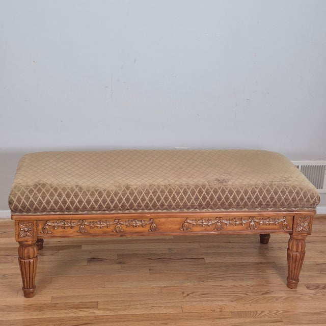 This is an oversized French country style bench or ottoman with a solid birch frame and padded seat. The frame has carved...