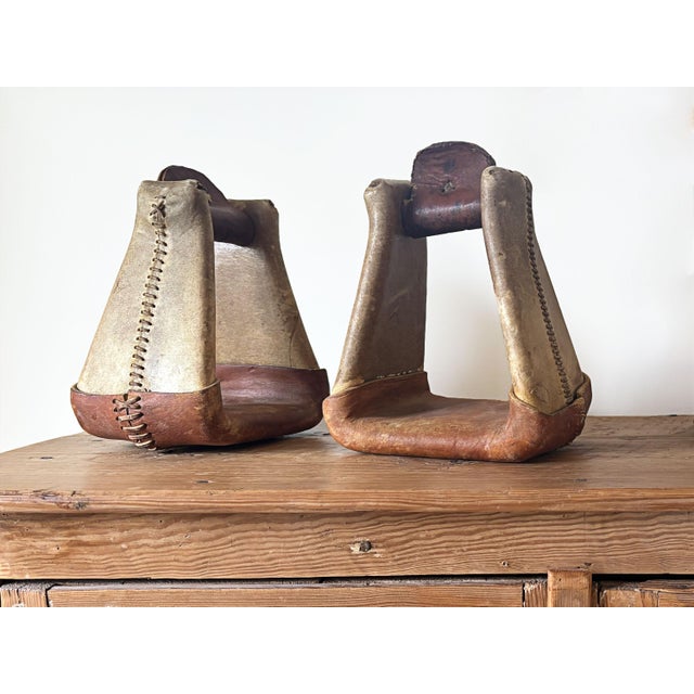 Add texture and warmth to your western decor with this large pair of vintage roping saddle stirrups. These stirrups are...