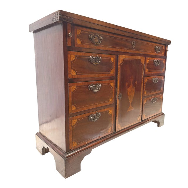 An Exceptionally Beautiful Bachelor's Chest constructed in mahogany, the central door inlaid with an urn, the drawers and...