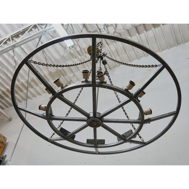 Crafted in France circa 1920–1930, this striking iron chandelier combines industrial strength with refined decorative...