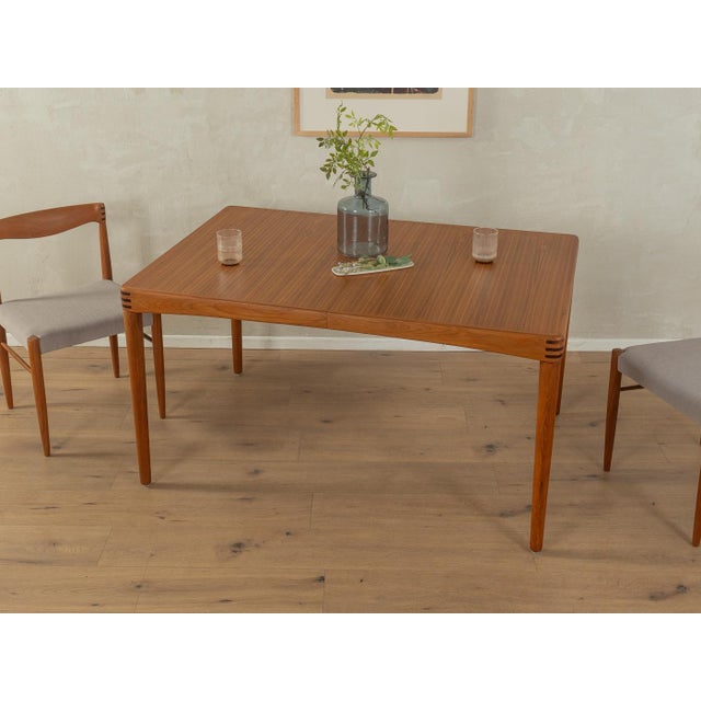Rare extendable teak dining table from the 1960s by H.W. Klein for Bramin. Solid frame and veneered tabletop with solid...