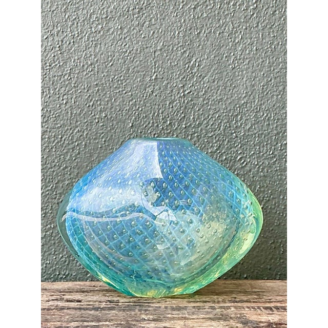 This vintage Italian art glass vase is a striking example of mid-century glassmaking, combining sculptural form with...