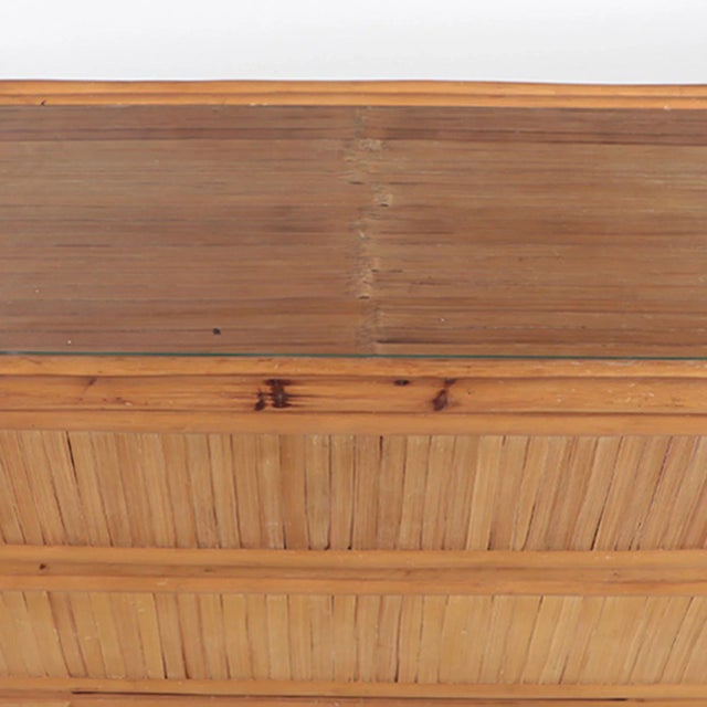 A vintage three drawer rattan dresser from the Phillipines resting on a stacked rattan base. Circa 1970