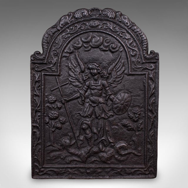 This is an antique church refectory fire back. An English, cast iron fireplace reflector with ecclesiastical taste, dating...