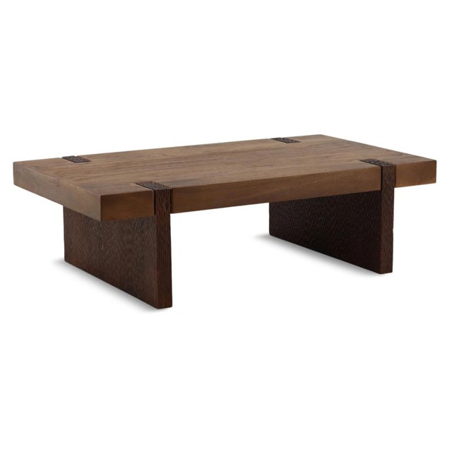 Rich walnut-brown finished solid mango wood coffee table. Modern architectural design featuring a thick slab top set into...