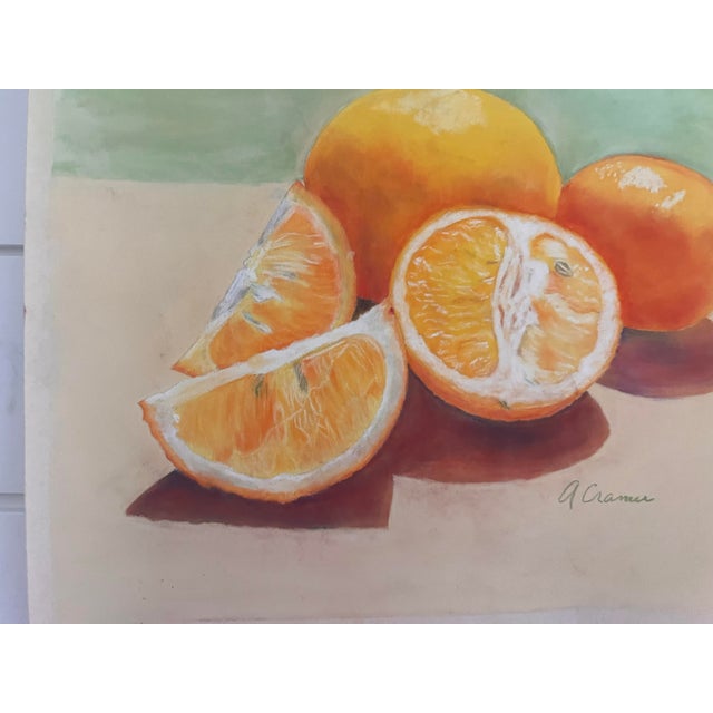 Original soft oil pastel still life of fresh oranges, signed by the artist in the lower right. A halved orange and two...