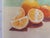 Original soft oil pastel still life of fresh oranges, signed by the artist in the lower right. A halved orange and two...