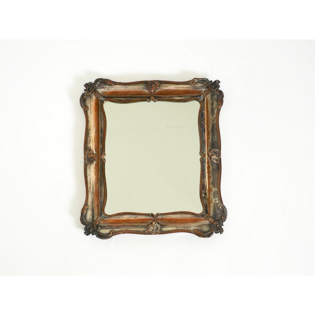 A beautiful and distinctive table mirror from the 1930s. The frame is made of wood and features a silver-plated finish...