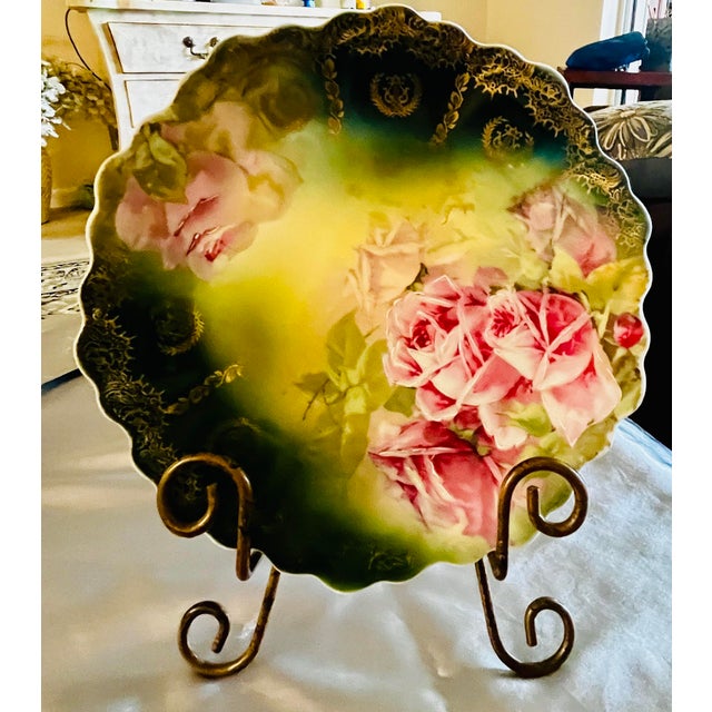 This exquisite porcelain plate brings timeless elegance into your home. It features lush, pink roses, and delicate gold...