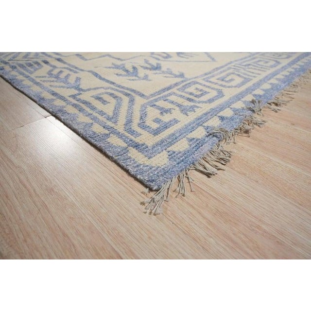This hand knotted pile rug features a primary color palette of ivory, beige, cream, and white. Constructed from a premium...