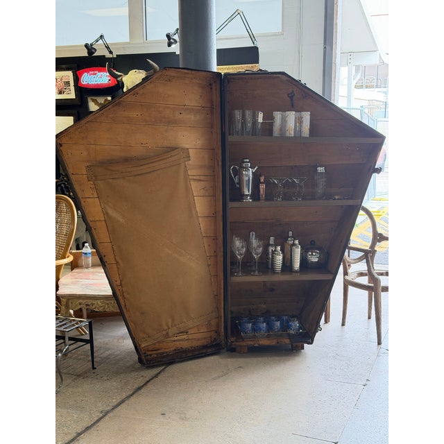 An extraordinary antique wooden harp travel case, believed to date to the 1920s, thoughtfully repurposed into a striking...
