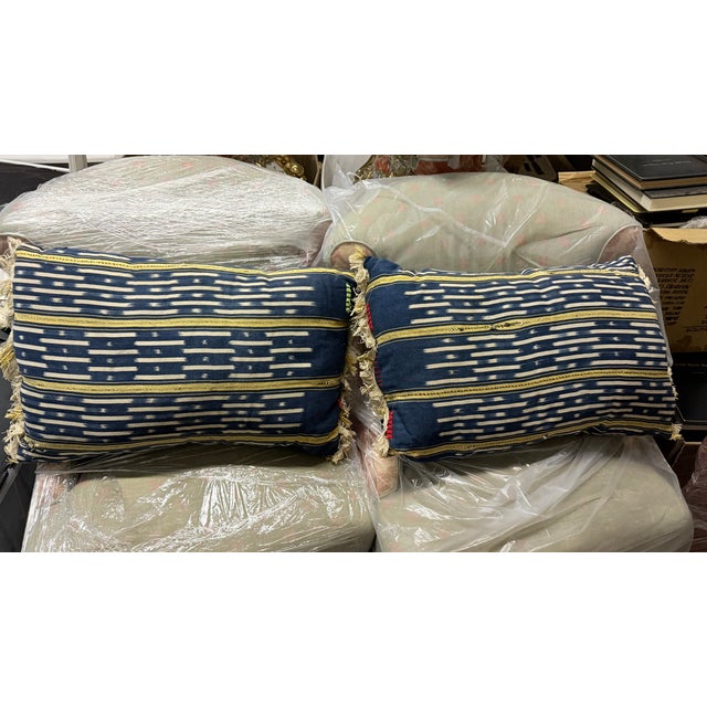 A pair of custom made elegant throw pillows in a rectangular lumbar shape sized 24" X 15" made of vintage African Baule...
