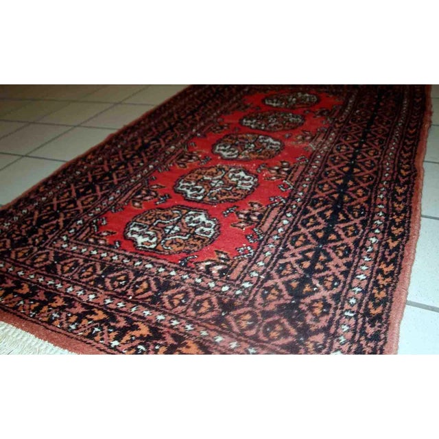 Vintage rug from Pakistan in distressed condition. The rug made in the end of 20th century in red wool. -condition:...