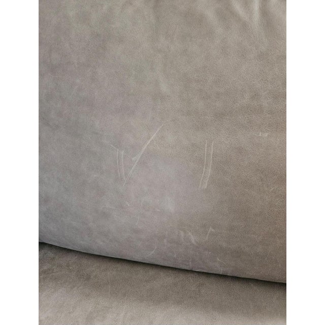 Wolf grey leather. Wood and recycled meta frame. Very well made. Good condition. See photos of light surface scratches. No...