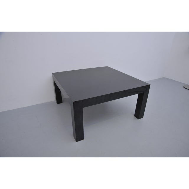 Coffee table with a black Formica surface and square decorative pattern. The table was originally purchased together with...