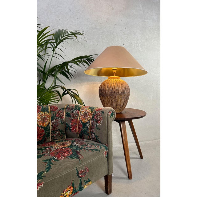 Large ceramic table lamp. Terracotta base with a large conical ‘kraft’ lampshade with a gold interior for optimal warm...