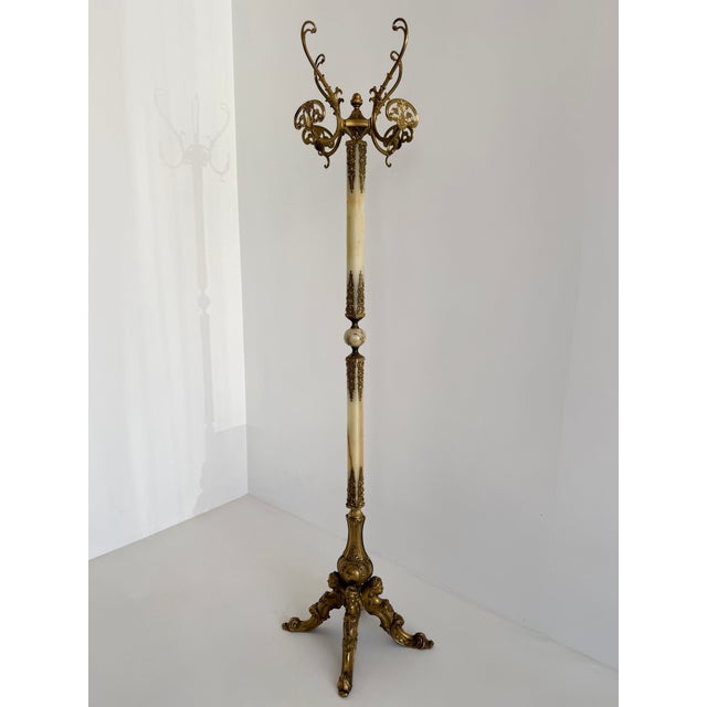 Product information an elegant italian coat rack from the 1960s, crafted from richly detailed brass and natural onyx...