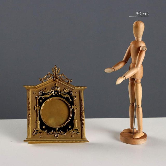 A picture frame in chiseled bronze and dark green velvet. The frame features a rich decoration of leafy scrolls, studs,...