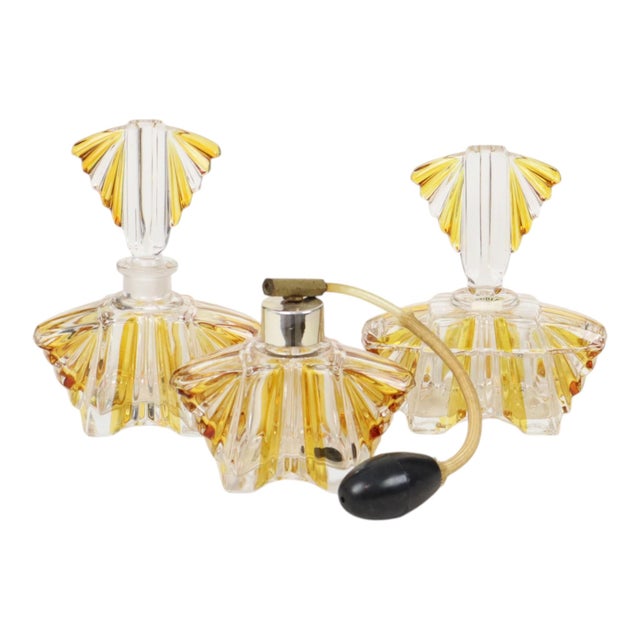 A charming and colorful set of three perfume bottles featuring a geometric design—a boudoir set in the distinctive Art...