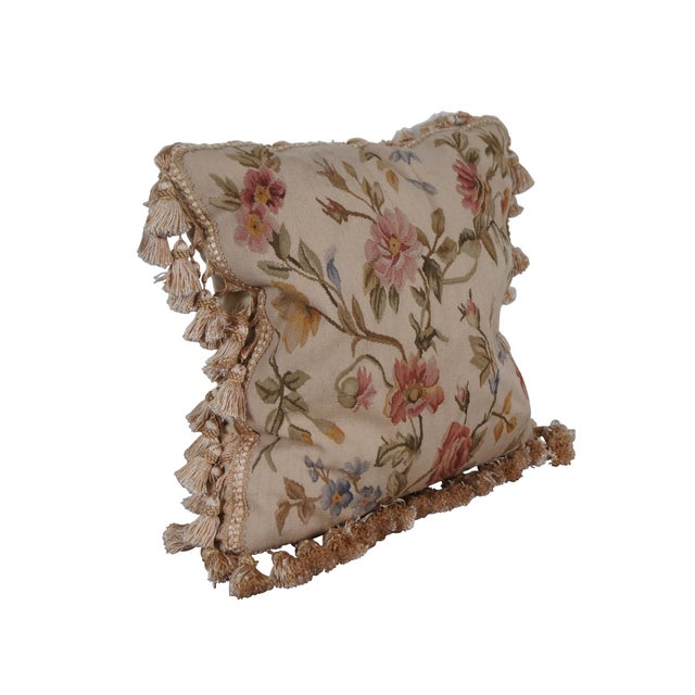 20th century square throw pillow, machine embroidered with green stems of pink and blue flowers on a beige background....