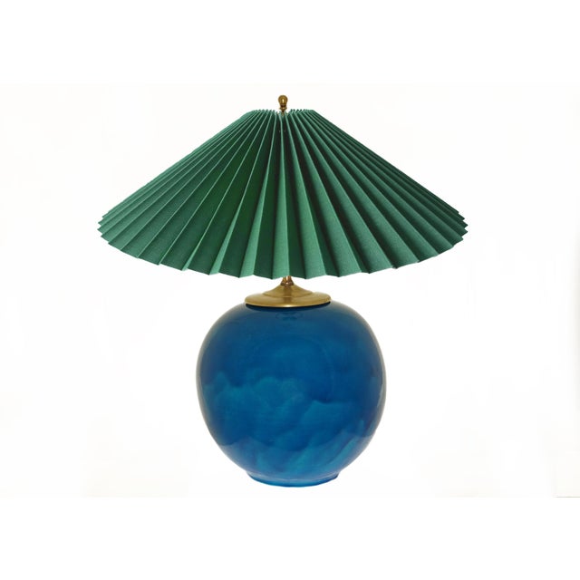Presenting a stunning spherical turquoise faience Primavera Atelier Art Deco table lamp. This stylish piece serves as both...