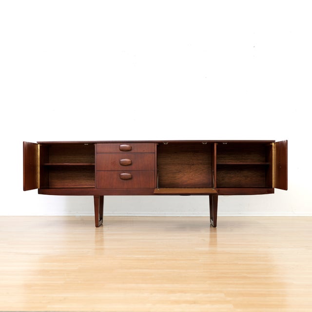 This vintage mid-century credenza was produced by Beautility Furniture during the 1960s. A wonderful minimalist design and...
