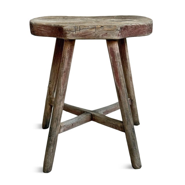 Rustic Mongolian vintage village stool hand-carved from durable expressive elm wood. Sculptural cloud-shaped seat resting...