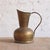 This 20th Century Belgian Brass Pitcher is a sculptural vintage vessel defined by its warm, timeworn patina and...