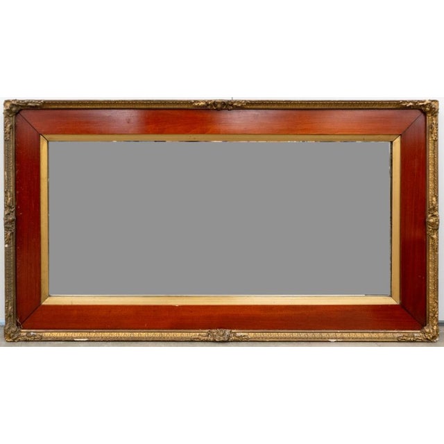 Early 20th Century Federal Style Cherry and Gilt Metal Wall Mirror. Measures 49" in width and 27" in height.