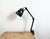 This vintage Industrial adjustable table lamp was produced in United Kingdom during the 1960s. The lamp has a green enamel...
