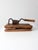 This antique tobacco cutter, with its worn wood and sturdy blade, evokes the bustling atmosphere of a country general...