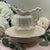 This decorative, Victorian-inspired set features a luminous white iridescent lusterware finish that catches the light with...