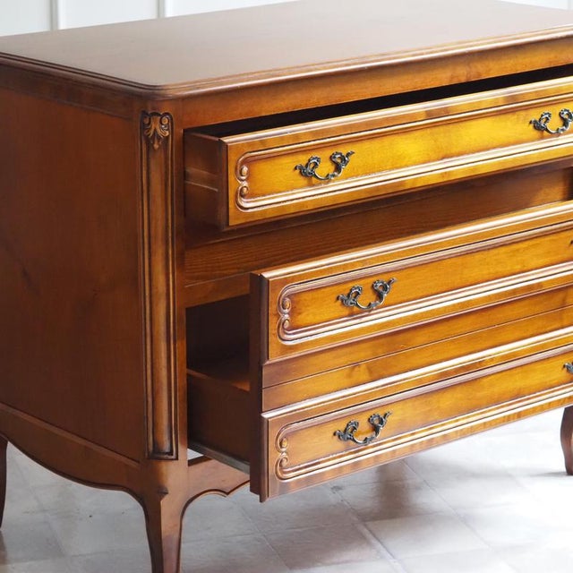 A cherrywood chest of drawers in the Louis XV style, crafted in the second half of the 20th century and modeled after...