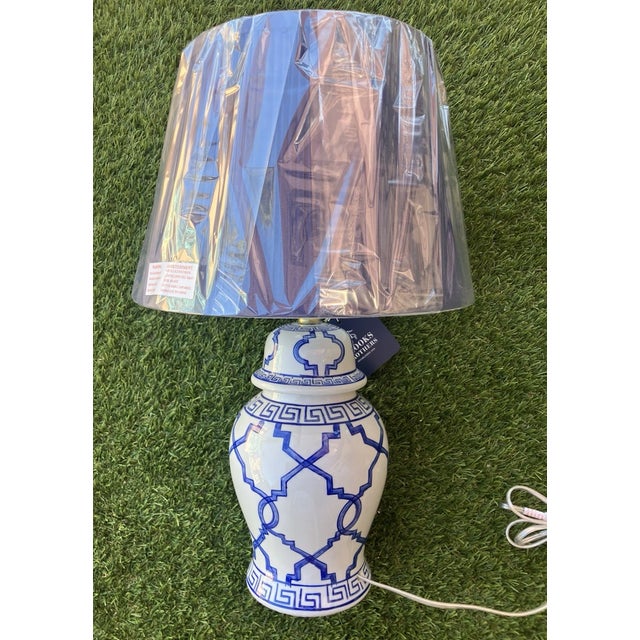 Bring timeless sophistication to your home with this elegant pair of Vintage Brooks Brothers Blue & White Ginger Jar Table...