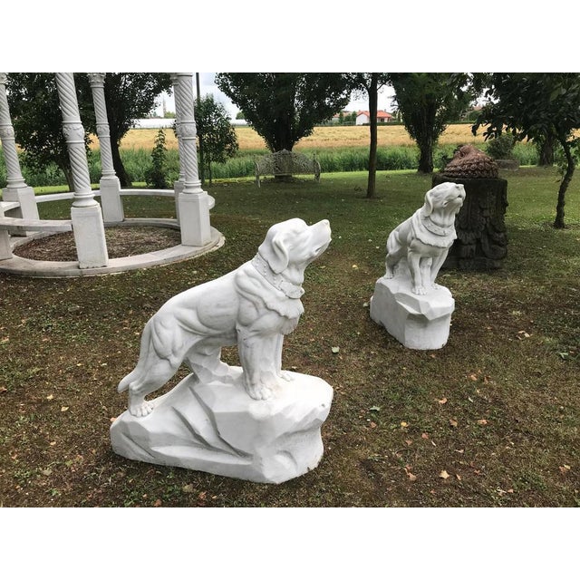 Impressive pair of dog sculptures, hand-carved in white Italian marble during the 1980s. Executed on a substantial scale,...