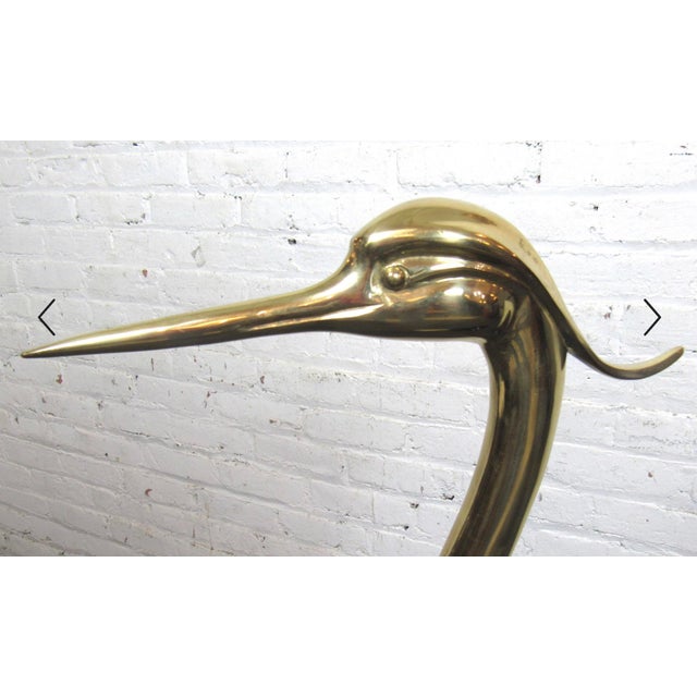 Decorative statue of water bird crane or egret. Black painted wood body with brass legs and head. Please confirm location...