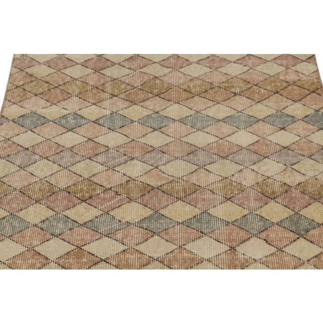 This vintage runner rug is a 3x9 Turkish distressed piece, made with hand-knotted wool circa mid-20th century. It is an...