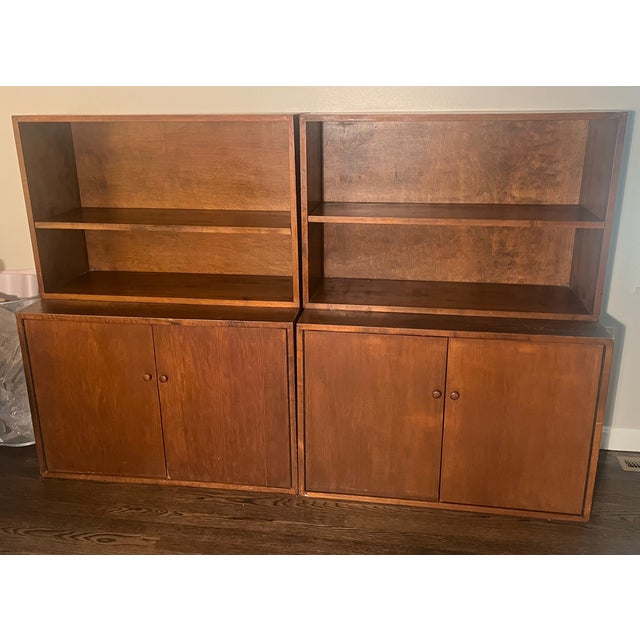 A versatile modern storage system which consists of 4 sections made of walnut. The bases each have two doors with magnetic...