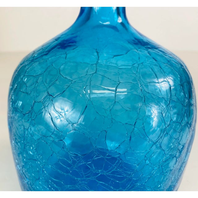 This is a large Blenko blue glass jar with its original stopper. This blue jar has a heavily crackled finish to the...