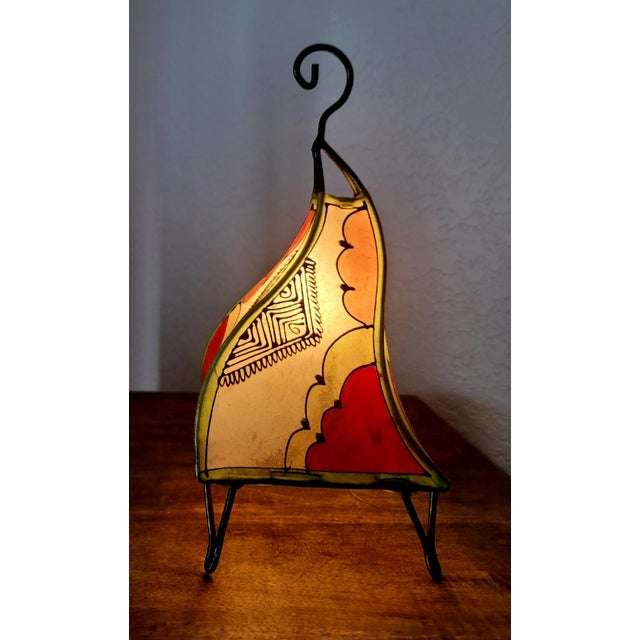 A radiant piece of Moroccan artistry, this handmade henna lamp brings the warmth of the Maghreb into any space. Crafted by...