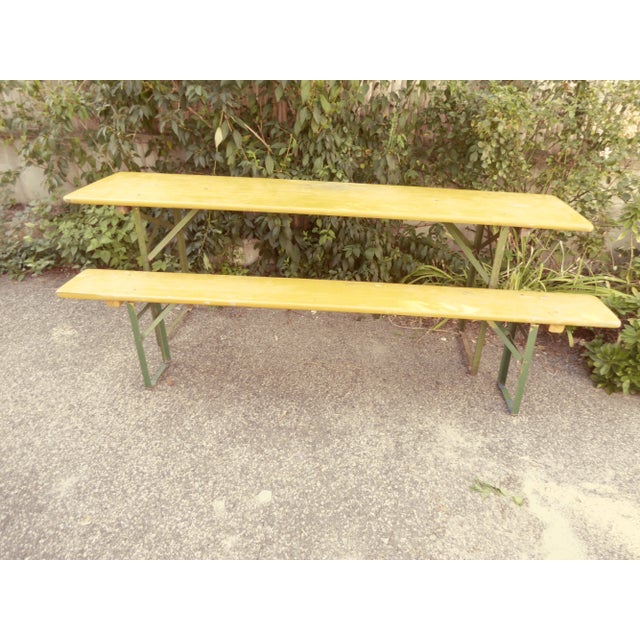 Vintage German collapsible beer hall table with two collapsible benches, painted yellow with green iron legs, weathered,...