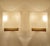 Pair vintage danish modern sconces, featuring a teak and brass support, black enameled back support, slightly rhombic...