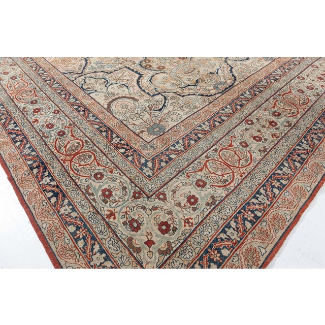 A late 19th century Kerman Persian rugs, the cream field with stepped compartments containing floral motifs and outlined...
