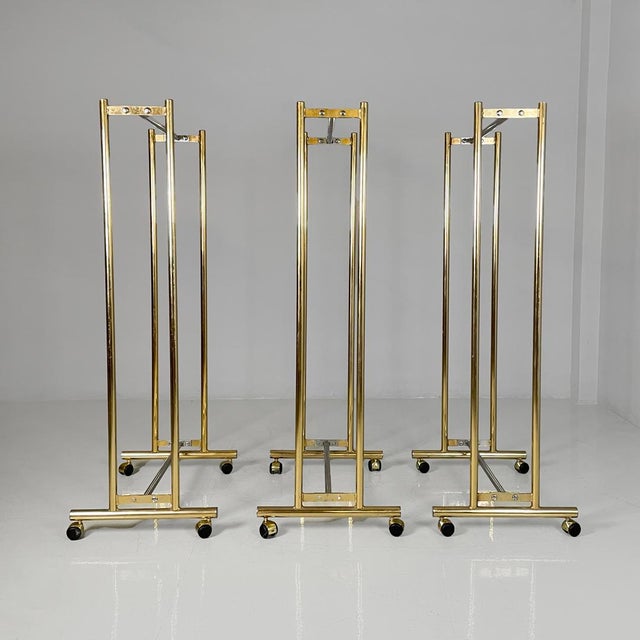 Italian modern metal coat racks gold and silver finish with casters, 1980s Set of three metal coat racks with a gold...